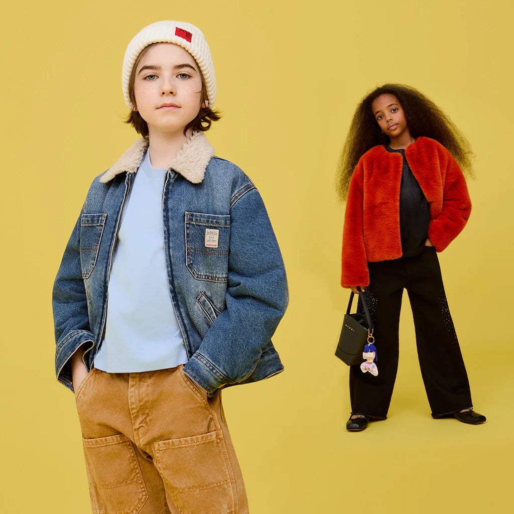 A boy and a girl wearing both cool and warm outfits, against a bright yellow background.
