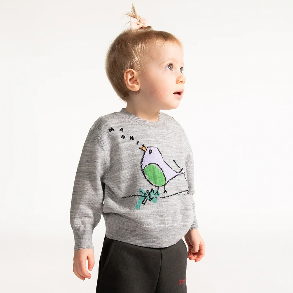 A baby wearing a comfy look with a cute pullover.