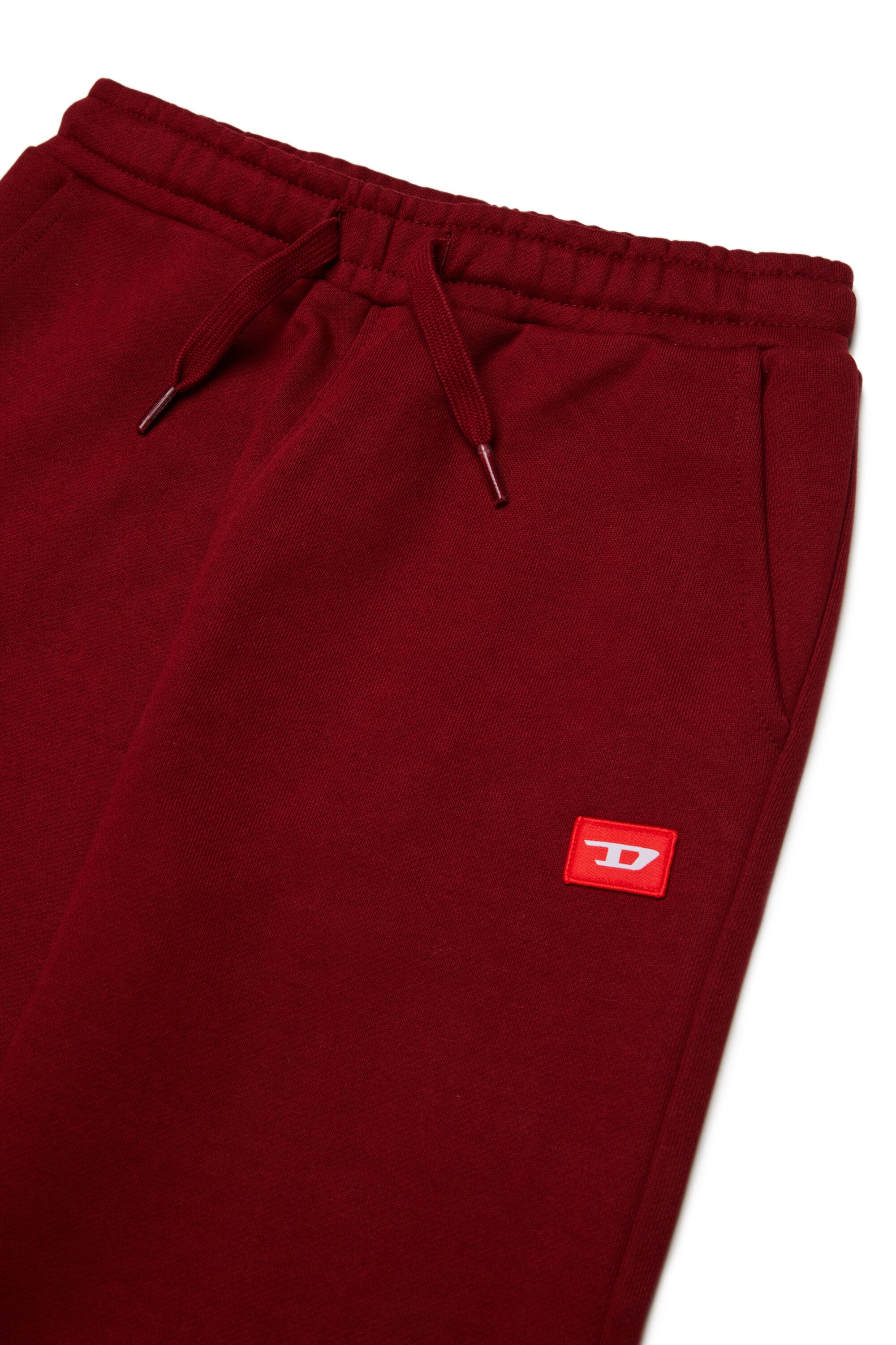Pantalon de jogging avec écusson "D" rouge