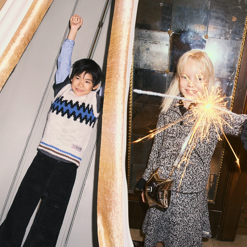 A boy and a girl having fun at wintertime, wearing warm and cool styles by N°21