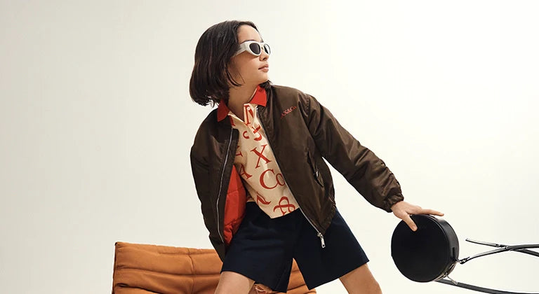 Jackets category - A girl wearing a cool outfit with a stylish jacket, sunglasses and a bag