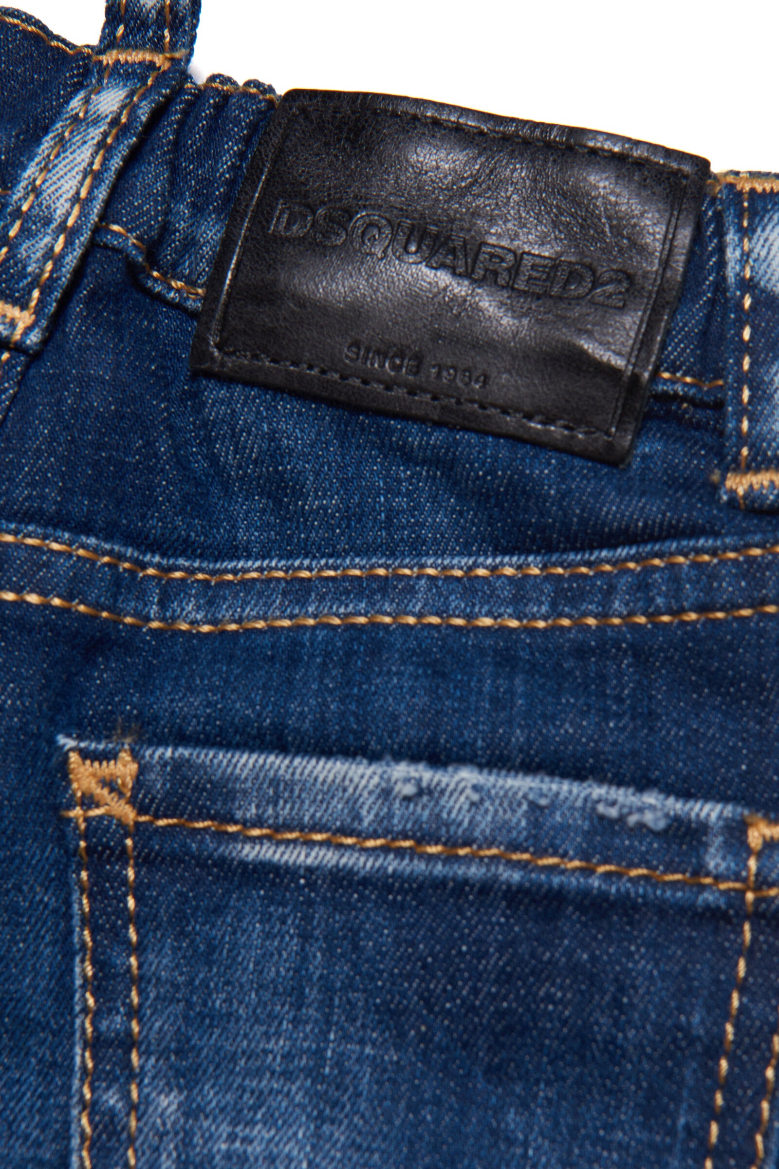 Shaded dark blue jeans with abrasions