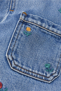 Light blue jeans jacket with embroidered flowers and patch