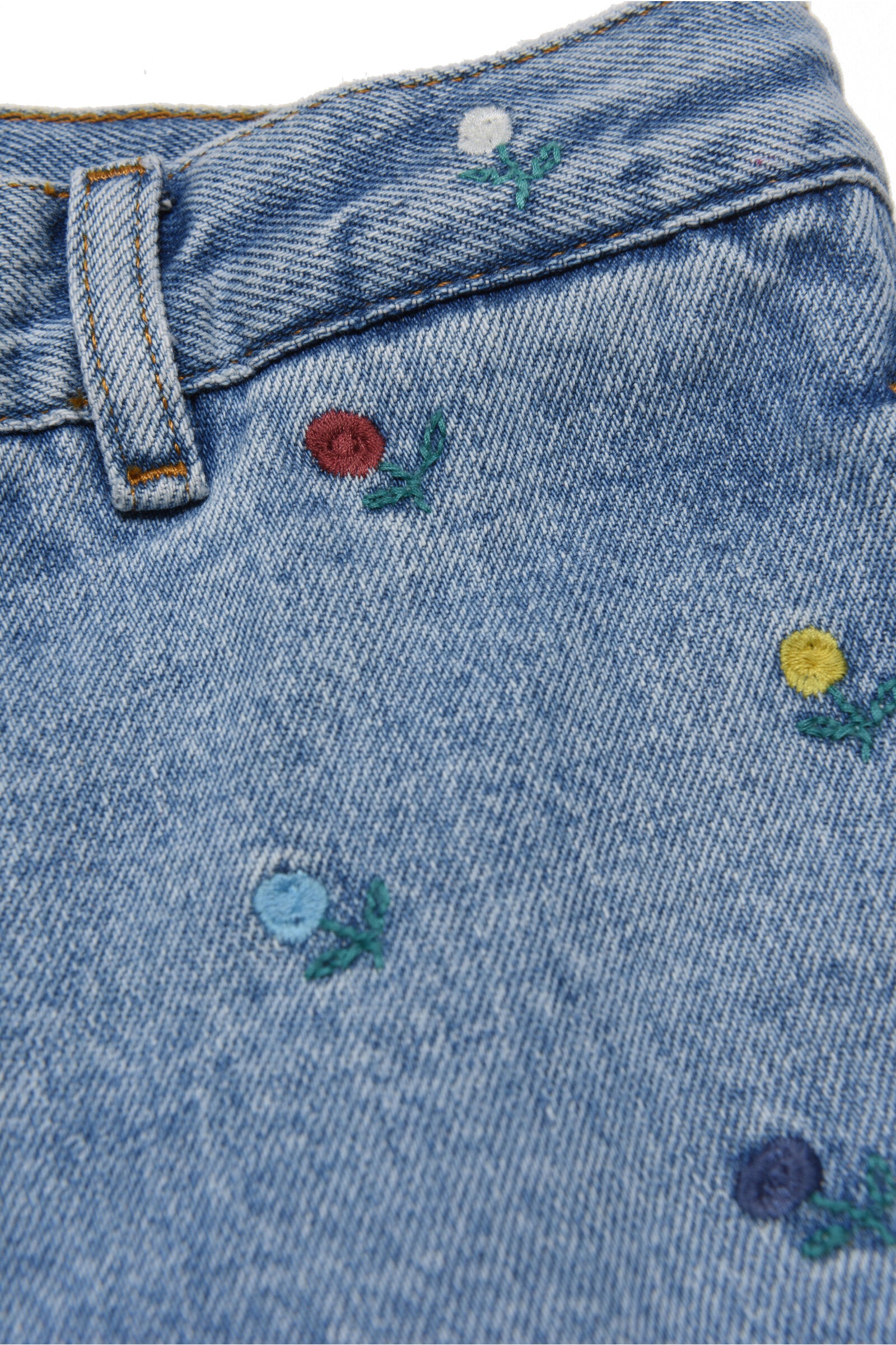 Light blue jeans pants with embroidered flowers and patch